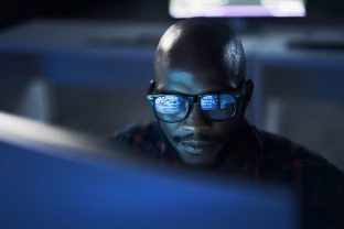 Man staring intently at data onscreen.